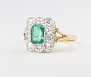 An 18ct yellow gold emerald and diamond cluster ring, the centre stone approx. 0.9ct surrounded by 10 brilliant cut diamonds approx. 1ct, size O, 3.6 grams