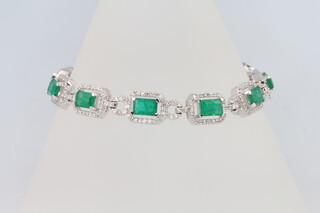 An 18ct white gold emerald and diamond line bracelet, the emeralds approx. 7.63ct, the brilliant cut diamonds 1.81ct, 17cm, 18.8grams