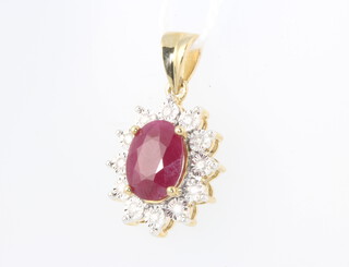 A 9ct oval ruby and diamond pendant, the centre stone approx. 1.85ct, the brilliant cut diamonds approx. 0.12ct, 22mm, 2.4 grams 