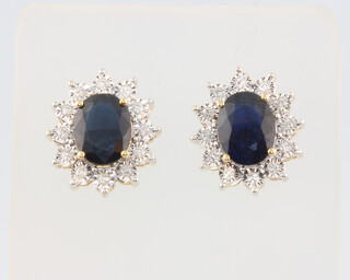 A pair of 9ct yellow gold oval sapphire and diamond ear studs, centre stones approx. 3.85ct, brilliant cut diamonds 0.24ct, 4.9 grams, 16mm 