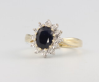 A 9ct yellow gold oval sapphire and diamond cluster ring, centre stone approx. 1.8ct diamonds 0.06ct, size M, 3.4 grams