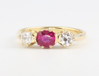 An 18ct yellow gold 3 stone ruby and diamond ring, the centre brilliant cut ruby approx. 0.75ct, the brilliant cut diamonds 0.51ct, size N, 3.4 grams together with a WGI gemological report 