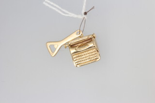 Two 9ct yellow gold charms in the form of a bottle opener and a typewriter 1.7 grams 