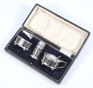 A silver 3 piece condiment set with pierced decoration Birmingham 1919, 66 grams 