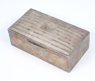 A rectangular engine turned silver cigarette box Chester 1928 16cm 