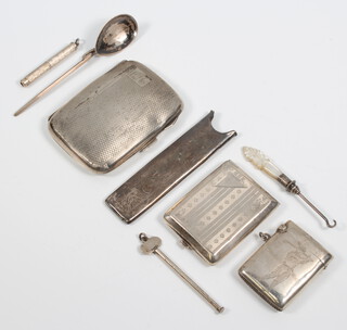 A silver engraved cigarette case Birmingham 1936, a comb case, vesta, match sleeve, spoon and minor items, weighable silver 120 grams 