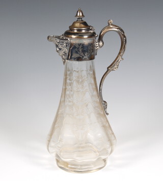 An Edwardian cut glass claret jug with plated mounts having a mask spout and scroll handle 31cm 