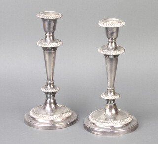 A pair of silver plated tapered candlesticks 24cm 