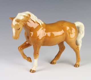 A Beswick figure of a stocky jogging mare, palomino gloss H855 modelled by Arthur Greddington 16cm  