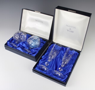 A pair of cut glass brandies and a pair of cut glass champagne flutes boxed, by Mappin & Webb