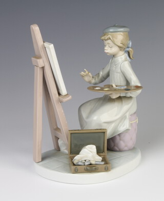 A Lladro figure of a seated girl artist before an easel 5363 17cm 