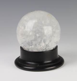 A white mottled glass "crystal ball" 12cm on a wooden stand 

