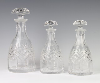 A pair of mallet shaped cut glass decanters with mushroom stoppers 20cm, a larger ditto 25cm 