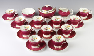 A Cauldon matched coffee set comprising 11 coffee cups, 12 saucers, a lidded sugar bowl, cream jug and slop bowl decorated with spring flowers 