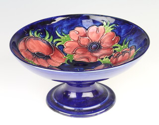 A Walter Moorcroft blue ground pedestal bowl decorated with anemones 19cm 