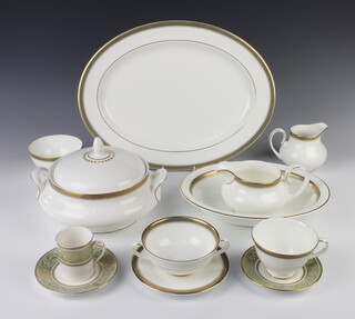 A Royal Doulton Clarendon pattern tea, coffee and dinner service comprising 4 coffee cans, 4 saucers, 8 tea cups, 8 saucers, 8 two handled cups, 7 saucers, 8 dessert bowls, two tureens and lids, a milk jug, a sauce boat, vegetable dish, 2 serving dishes, an oval plate, 9 small plates, 8 medium plates, 8 dinner plates, sugar bowl (see condition report for quantity of seconds) 