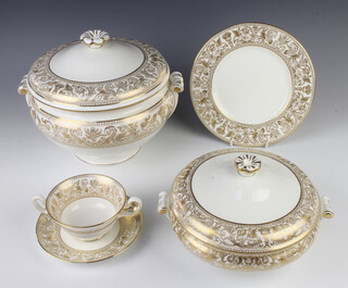 A Wedgwood gold Florentine dinner service comprising 10 two handled cups, 14 saucers, 13 small plates, 14 medium plates, 14 large plates, 14 dinner plates, 2 vegetable tureens and covers, a soup tureen and cover, 2 dishes 