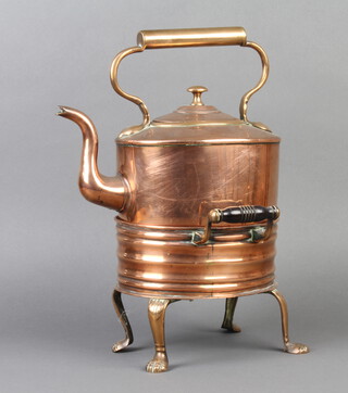 A Victorian oval copper kettle raised on a twin handled hot plate stand with turned ebony handles 41cm x 25cm x 25cm 