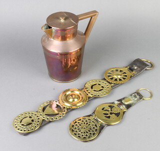 A Dresser style lidded copper jug, the base marked 3JM (some dents) 19cm x 10cm together with 2 Victorian leather Martingales hung 7 horse brasses  