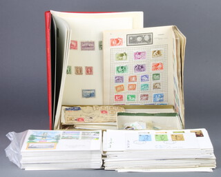 A red album of Elizabeth II mint and used GB stamps, a universal album of postage stamps, loose stamps, first day covers etc 