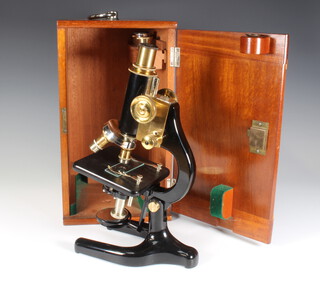 A Charles Perry students single draw pillar microscope no.5 7309 contained in a mahogany carrying case 