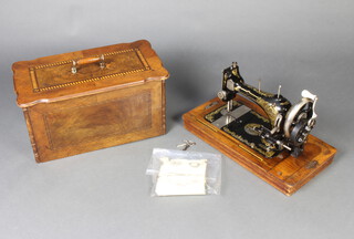 W J Harris & Co, a manual sewing machine no. 889 910 complete with instructions and carrying case 