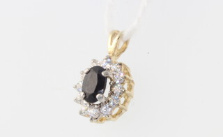 A 9ct yellow gold blue sapphire and paste pendant 1.2 grams, 10mm