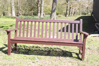 A slatted wooden garden bench marked Newton Drive Servicemen's Club 70cm h x 62cm 