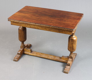 A 1930's rectangular oak refectory style coffee table raised on cup and cover supports with H framed stretcher 52cm h x 69cm w x 42cm l