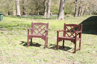 A pair of painted hardwood slatted garden armchairs 83cm h x 53cm w x 60cm d 