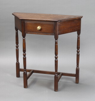 A 1930's oak credence style side table fitted a drawer raised on turned and block supports 76cm h x 77cm w x 32cm d 