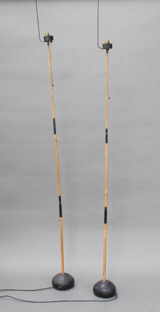 A pair of 1930's style bamboo standard lamps raised on circular bases 193cm h x 13cm 