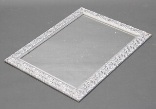 A rectangular plate wall mirror contained in a decorative silver effect frame 84cm x 63cm