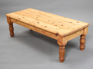 A rectangular pine coffee table raised on turned supports 46cm h x 144cm l x 59cm w (some pitting and contact marks to the top) 