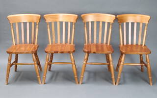 A set of 4 Marks and Spencers stick and rail back Windsor style dining chairs 