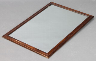 A rectangular plate wall mirror contained in a mahogany finished frame 84cm x 57cm 