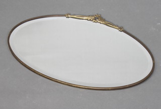 An Art Deco oval bevelled plate wall mirror contained in a decorative gilt frame surmounted by swags 36cm h x 56cm w 