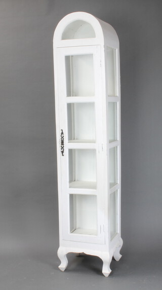 A white painted arch shaped display cabinet enclosed by a glazed panelled door, on ogee bracket feet 196cm h x 40cm w x 35cm d 
