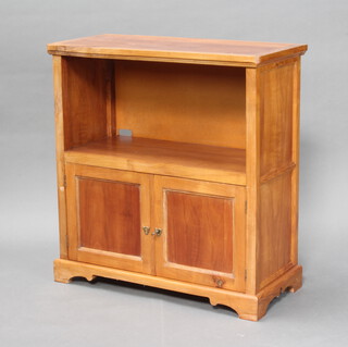 A hardwood cabinet fitted a recess above cupboard enclosed by panelled doors, on a platform base 84cm h x 79cm w x 36cm d 