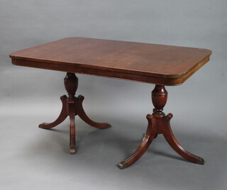 A mahogany Regency style twin pillar pedestal dining table on splayed legs 76cm h x 132cm l x 91cm w 