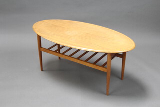 A 1960's oval woodgrain effect 2 tier laminate and beech framed coffee table 45cm h x 107cm l x 52cm w
