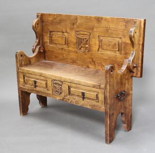 A Spanish carved pine settle, the hinged back decorated with armorial, the base fitted 2 drawers 85cm h x 112cm w x 38cm d 