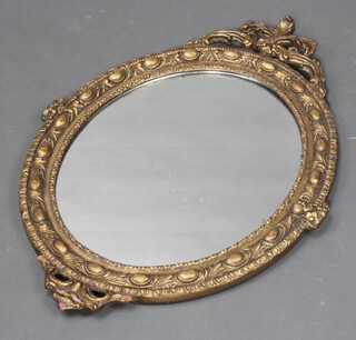 A 19th Century style oval plate wall mirror contained in a decorative gilt frame 79cm x 56cm  (some plaster work missing to the base of the frame)