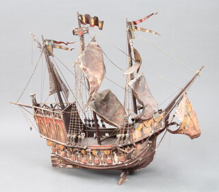 A wooden model of a 3 masted galleon 77cm h x 100cm l x 22cm w