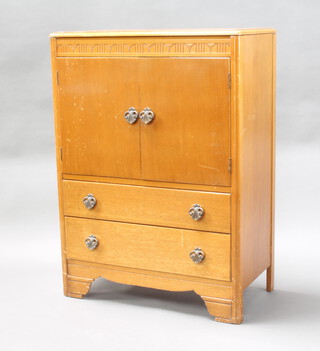 A 1960's light oak tall boy 104cm h x 77cm w x 41cm d (some water marks and light scratches in places)