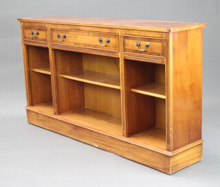 A Georgian style yew bookcase with crossbanded top, fitted 3 drawers to the top, raised on a platform base 84cm h x 153cm w x 31cm d 