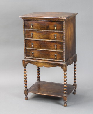 A 1920's oak 4 drawer sheet music chest, on bobbin turned supports with undertier 94cm h x 50cm w x 38cm d (light water marks to the top) 