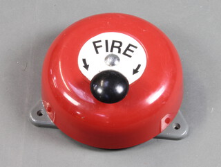 A circular red painted metal fire bell 9cm h x 26cm diam.  