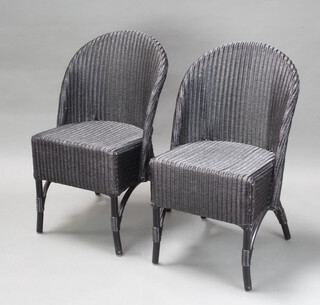 A pair of W Lusty & Sons black painted Lloyd Loom nursing chairs 