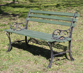 An iron and wooden slatted garden bench 76cm h x 129cm w x 43cm d 